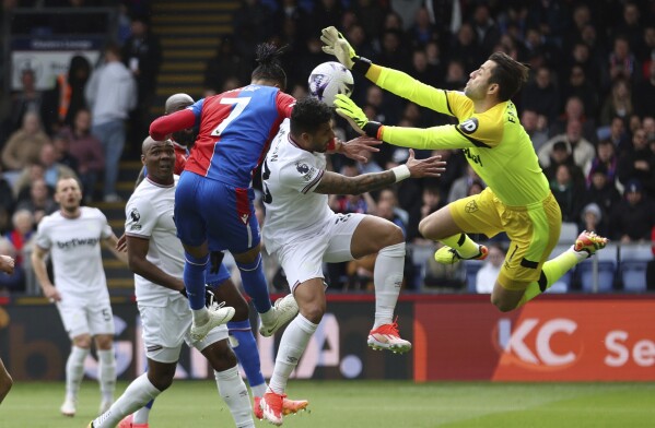 Crystal Palace's Michael Olise, center left, scores their side's first goal of the game during the English Premier League soccer match between West Ham United and Crystal Palace at Selhurst Park, London, Sunday April 21, 2024. (Steven Paston/PA via AP)