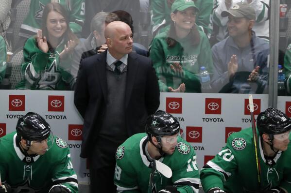 Dallas Stars head coach Jim Montgomery, Andrew Cogliano (11), Jason Dickinson (18) and Corey Perry (10) watch play against the Vegas Golden Knights in the third period of an NHL hockey game in Dallas, Monday, Nov. 25, 2019. The Stars won 4-2. (AP Photo/Tony Gutierrez)