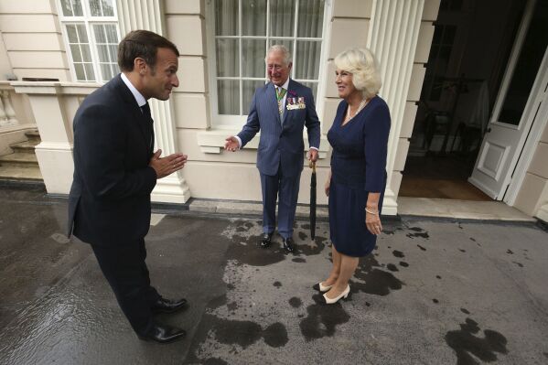 FILE - Britain's Prince Charles and Camilla, Duchess of Cornwall welcome French president Emmanuel Macron to Clarence House in London, Thursday June 18, 2020. King Charles III will travel to France later in Sept. 2023 finally proceeding with a State Visit that was postponed in March due to fears that protesters demonstrating against President Emanuel Macron’s economic policies would disrupt the pageantry. Charles and Queen Camilla will visit Paris and Bordeaux from Sept. 20-22. (Jonathan Brady/Pool via AP, File)