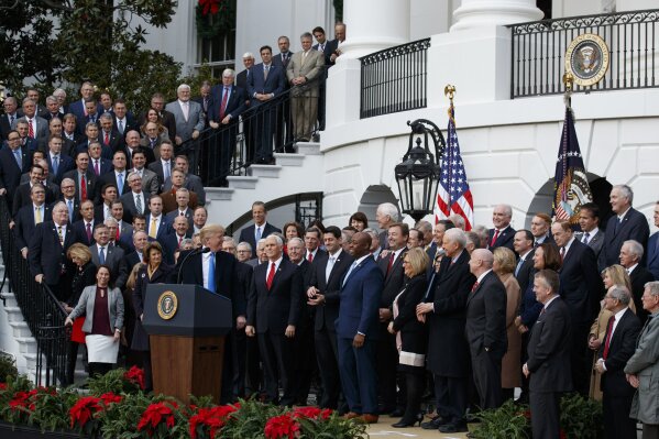 
              FILE - In this Dec. 20, 2017 file photo, President Donald Trump speaks during an event on the South Lawn of the White House in Washington, to acknowledge the final passage of tax overhaul legislation by Congress.  Perhaps nowhere is the choice facing voters more vivid than in the battle for control of the House, where Democrats are fielding more women and female minority candidates than ever while Republicans are trying to hold the majority with mostly white men. The disparity highlights a trend that has been amplified under President Donald Trump, with the two parties increasingly polarized along racial and gender lines as much as by the issues. (AP Photo/Evan Vucci)
            