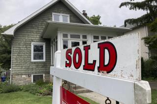 FILE - A "sold" is posted outside a single family home in a residential neighborhood, in Glenside, Pa., Wednesday, Aug. 4, 2021.  Mortgage buyer Freddie Mac reported Thursday, Oct. 27, 2022,  that the average on the key 30-year rate jumped to 7.08% from 6.94% last week.(AP Photo/Matt Rourke, File)