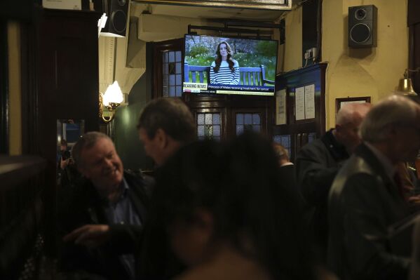 People watch a broadcast of an announcement by the Princess of Wales, in the Westminster Arms public house in Westminster, England, Friday, March 22, 2024. (Aaron Chown/PA via AP)