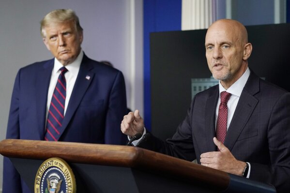 President Donald Trump listens as Dr. Stephen Hahn, commissioner of the U.S. Food and Drug Administration, speaks during a media briefing in the James Brady Briefing Room of the White House, Sunday, Aug. 23, 2020, in Washington.(AP Photo/Alex Brandon)