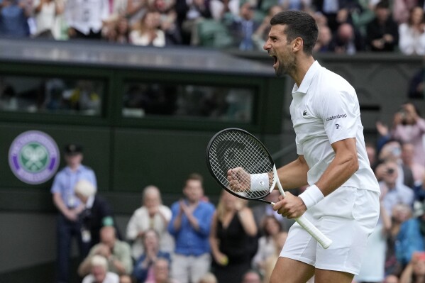 Serbia's Novak Djokovic celebrates after beating Russia's Andrey Rublev to win their men's singles match on day nine of the Wimbledon tennis championships in London, Tuesday, July 11, 2023. (AP Photo/Kirsty Wigglesworth)