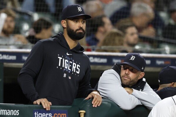 Detroit Tigers outfielder Riley Greene, left, and pitching coach Chris Fetter watch the baseball game against the Cincinnati Reds during the seventh inning Wednesday, Sept. 13, 2023, in Detroit. (AP Photo/Duane Burleson)