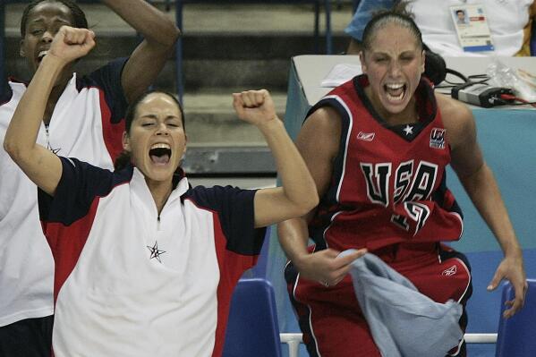 FILE - United States' Sue Bird, left, and Diana Taurasi, right, cheer from the bench near the end of the team's 66-62 victory against Russia in a women's basketball semifinal at the Olympic Games in Athens, Greece, Aug. 27, 2004. Bird captured two college national titles at UConn, four WNBA championships with the Seattle Storm and five Olympic gold medals with the U.S. (AP Photo/Elise Amendola, File)