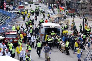 FILE - In this April 15, 2013 file photo, medical workers aid injured people following an explosion at the finish line of the 2013 Boston Marathon in Boston. Twin bombs near the finish line of one of the world's most storied races killed three people and injured 260 others, many of whom lost their legs, five years ago on April 15, 2013. (AP Photo/Charles Krupa, File)