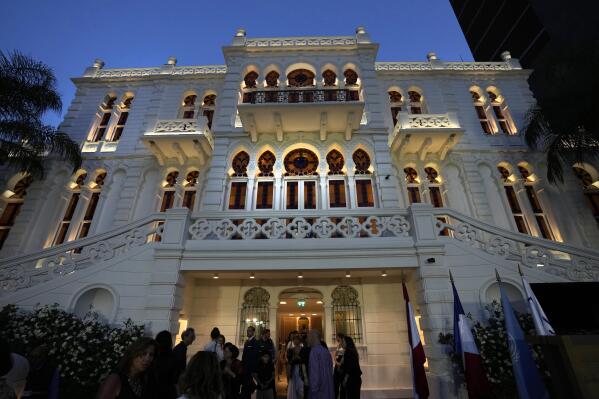 A crowd of people gather at the courtyard of the Sursock Museum during an opening event for the iconic venue in Beirut, Lebanon, Friday, May 26, 2023. The museum has reopened to the public, three years after after a deadly explosion in the nearby Beirut port reduced many of its treasured paintings and collections to ashes. (AP Photo/Hussein Malla)