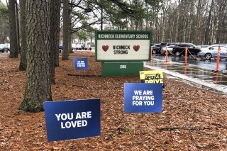 FILE - Signs stand outside Richneck Elementary School in Newport News, Va., Jan. 25, 2023. The mother of a 6-year-old boy who shot his teacher at the Virginia school is expected to plead guilty in federal court Monday, June 12, 2023, to using marijuana while possessing a firearm, which is illegal under U.S. law. (AP Photo/Denise Lavoie, File)