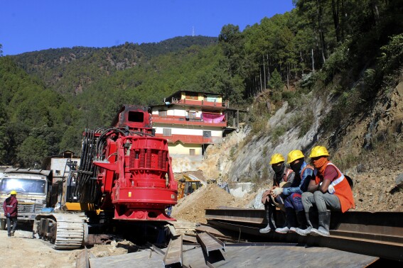 Rescuers rest at the site of an under-construction road tunnel that collapsed in Silkyara in the northern Indian state of Uttarakhand, Friday, Nov. 24, 2023. Rescuers are racing to evacuate 41 construction workers who have been trapped for nearly two weeks. (AP Photo)