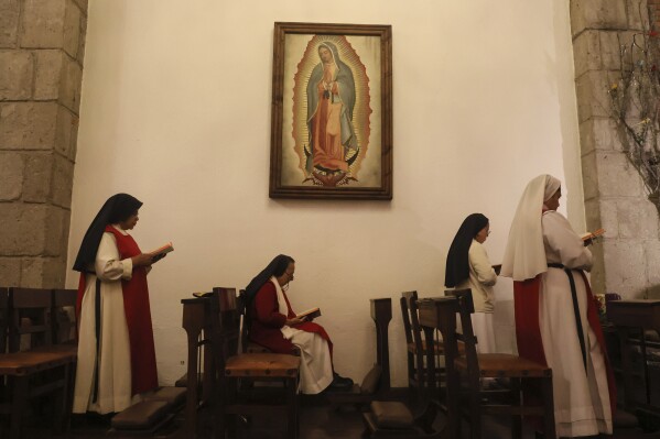 From left, nuns Maria Auxiliadora Estrada, 59, Maria Ines Maldonado, 76, Patricia Marin, 28 and Maria de Jesus Frayle, 24, attend morning Mass in the chapel at the Convent of the Mothers Perpetual Adorers of the Blessed Sacrament in Mexico City, Thursday, Dec. 7, 2023. (AP Photo/Ginnette Riquelme)