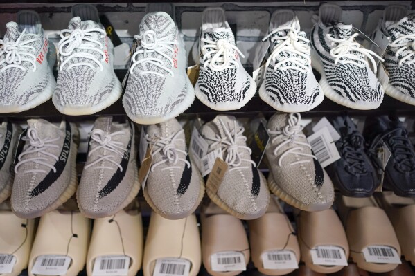 FILE - Yeezy shoes made by Adidas are displayed at Laced Up, a sneaker resale store, in Paramus, N.J., on Oct. 25, 2022. Adidas forecast it may have to write off the remaining 300 million euros ($320 million) worth of Yeezy shoes left unsold after it cut ties with rapper Ye, formerly known as Kanye West. The company on Wednesday, Nov. 8, 2023 said it will decide in the coming weeks whether or not to do a third release of the shoes next year to generate more donations to groups fighting anti semitism. (AP Photo/Seth Wenig, File)