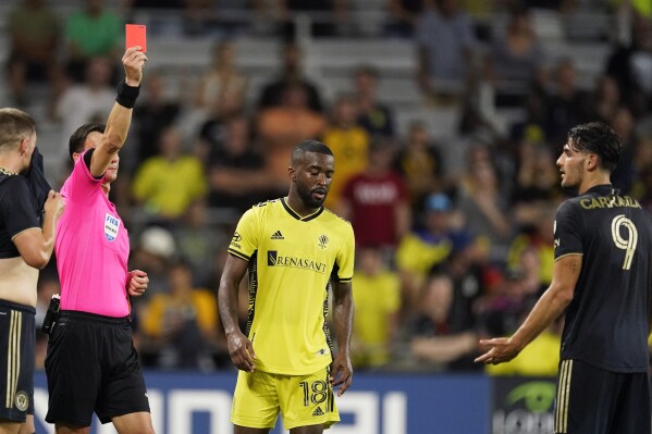 Nashville SC defender Shaq Moore (18) and Philadelphia Union forward Julián Carranza (9) each receive a red card during the second half of an MLS soccer match Wednesday, July 12, 2023, in Nashville, Tenn. (AP Photo/George Walker IV)