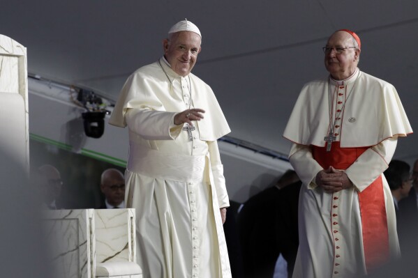Pope Francis, left, is flanked by Cardinal Kevin Farrell during a vigil at Campo San Juan Pablo II in Panama City, Jan. 26, 2019. (AP Photo/Alessandra Tarantino, File )