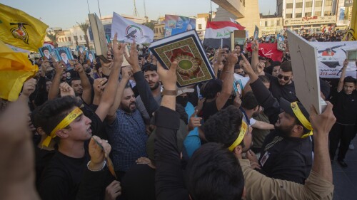 Iraqis raise copies of the Quran, Muslims' holy book, during a protest in Tahrir Square, Thursday، July 20, 2023 in Baghdad, Iraq. The protest was in response to the burning of Quran in Sweden. (AP Photo/Adil AL-Khazali)