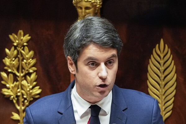 French Prime Minister Gabriel Attal speaks to the lawmakers at the National Assembly in Paris, Tuesday, Jan. 30, 2024. French Prime Minister Gabriel Attal said on Tuesday his top priority is to boost employment in his general policy address to lawmakers, three weeks after he was appointed. Attal is facing his first major challenge as angry farmers are protesting across the country and around Paris against low wages and other problems.(AP Photo/Michel Euler)