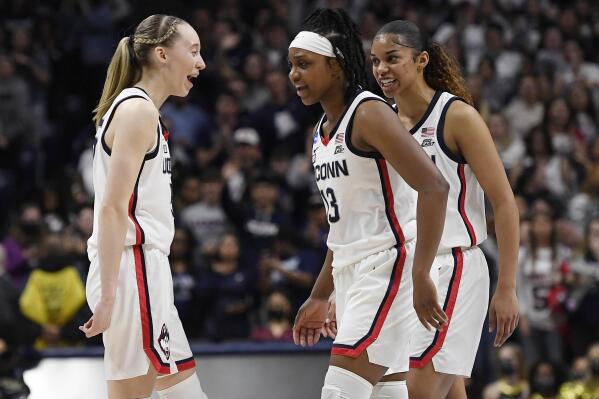 Connecticut's Paige Bueckers, left, Christyn Williams, center, and Evina Westbrook react during the second half of a second-round women's college basketball game against Central Florida in the NCAA tournament, Monday, March 21, 2022, in Storrs, Conn. (AP Photo/Jessica Hill)
