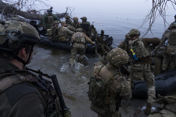 Ukrainian soldiers board a boat on the banks of the Dnipro River at the front line near Kherson, Ukraine, on Sunday, October 15, 2023.  (AP Photo/Mstislav Chernov, File)