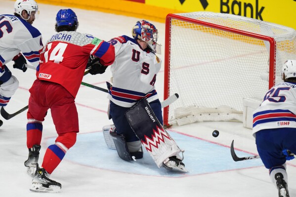 Czech Republic's Pavel Zacha, left, scores his sides first goal past United States' goalkeeper Charlie Lindgren during the quarterfinal match between Czech Republic and United States at the Ice Hockey World Championships in Prague, Czech Republic, Thursday, May 23, 2024. (AP Photo/Petr David Josek)