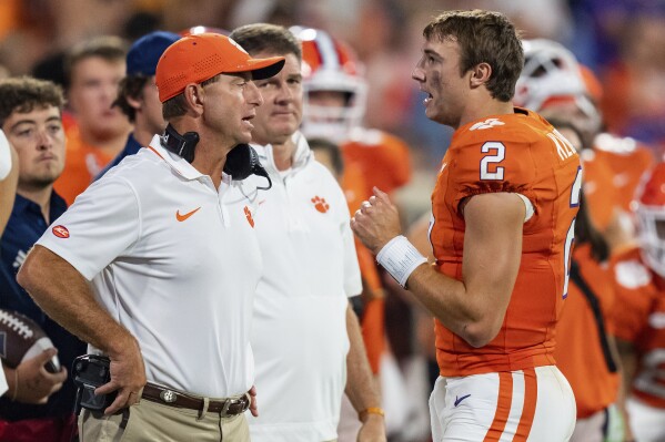 Clemson head coach Dabo Swinney, front left, talks with quarterback Cade Klubnik (2) during the second half of an NCAA college football game against Florida Atlantic, Saturday, Sept. 16, 2023, in Clemson, S.C. (AP Photo/Jacob Kupferman)