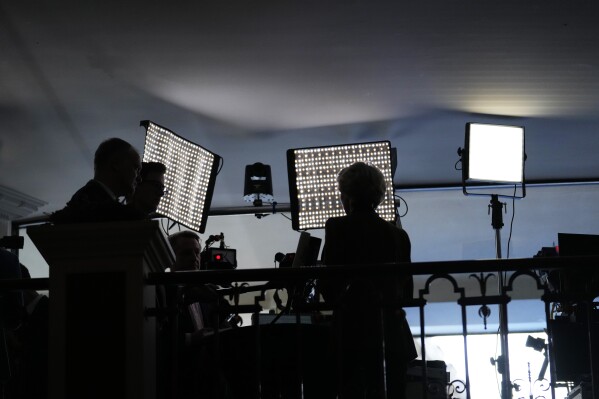 FILE - European Commission President Ursula von der Leyen, center, is silhouetted against television lights while giving an interview at the Munich Security Conference in Munich, Feb. 18, 2023. The Munich Security Conference has been long regarded as a celebration of the U.S.-led post-World War II international order. In 2024, though, it will be more of a reflection of America's political turmoil. (AP Photo/Petr David Josek, File)