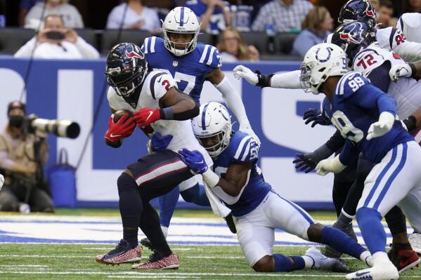 Houston Texans' Mark Ingram (2) is tackled by Indianapolis Colts' Bobby Okereke (58) during the first half of an NFL football game, Sunday, Oct. 17, 2021, in Indianapolis. (AP Photo/Michael Conroy)