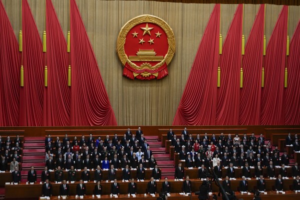 Delegates sing the national anthem during during the opening session of the National People's Congress (NPC) at the Great Hall of the People in Beijing, China, Tuesday, March 5, 2024. (AP Photo/Ng Han Guan)