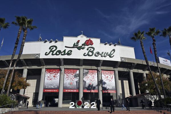 The exterior of the stadium is seen before the Rose Bowl NCAA college football game between Utah and Ohio State Saturday, Jan. 1, 2022, in Pasadena, Calif. Flipping the current college football playoff from four-teams to a 12-teams for the final two years of the current television contract will give those in charge of the postseason a look at how it works before committing to anything long term. But, The Granddaddy of Them All wants the CFP management committee to assure game organizers that their game will continue to be played annually on New Year's Day. (AP Photo/John McCoy, File)