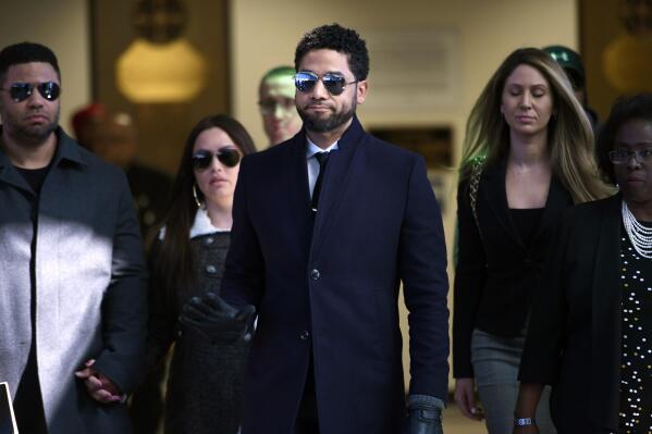 FILE - In this March 26, 2019 file photo, actor Jussie Smollett gestures as he leaves Cook County Court after his charges were dropped in Chicago.  Smollett faces new charges for reporting an attack that Chicago authorities contend was staged to garner publicity, according to media reports Tuesday, Feb. 11, 2020. The charges include disorderly conduct counts, according to the reports that cite unidentified sources.  (AP Photo/Paul Beaty, File)