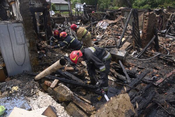 Rescue workers extinguish a fire of a house destroyed by a Russian drone strike in Pryluky village, Ukraine, Thursday, June 5, 2025. (AP Photo/Evgeniy Maloletka)