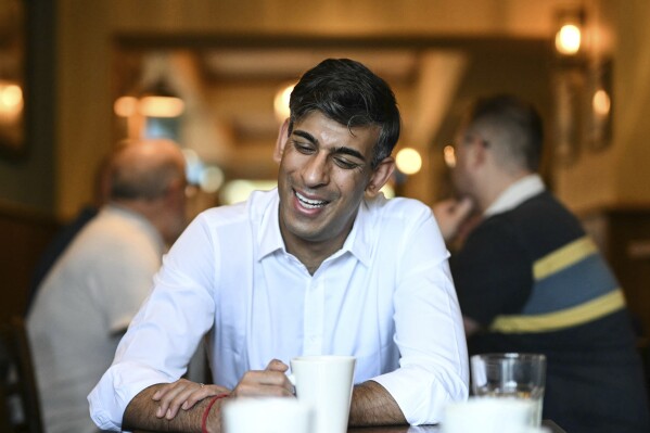 Britain's Prime Minister and Conservative Party leader Rishi Sunak reacts as he meets with veterans at a community breakfast during a party campaign event in the build-up to the UK general election on July 4, in Northallerton, northeastern England, on Saturday, May 25, 2024. (Oli Scarff/Pool Photo via AP)