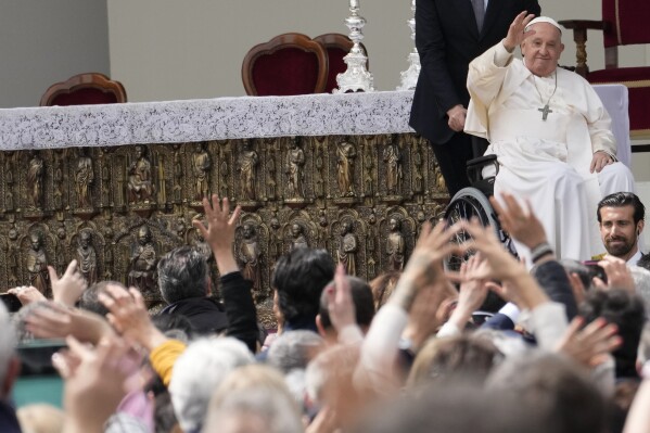 Pope Francis waves to faithful at the end of a mass in St. Mark's Square, Venice, Italy, Sunday, April 28, 2024. The Pontiff arrived for his first-ever visit to the lagoon town including the Vatican pavilion at the 60th Biennal of Arts. (AP Photo/Antonio Calanni)