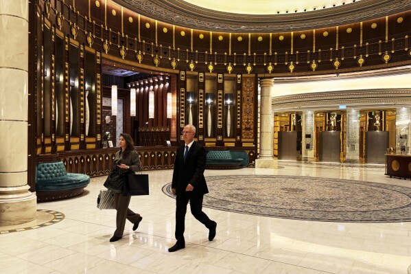 CORRECTS THE IDENTITY OF PERSON ON LEFT - Kirill Dmitriev, the head of the Russian Direct Investment Fund, right, walks with an unidentified member of his team across the Ritz Carlton hotel in Riyadh, Saudi Arabia, Tuesday, Feb. 18, 2025. (AP Photo/Baraa Anwer)
