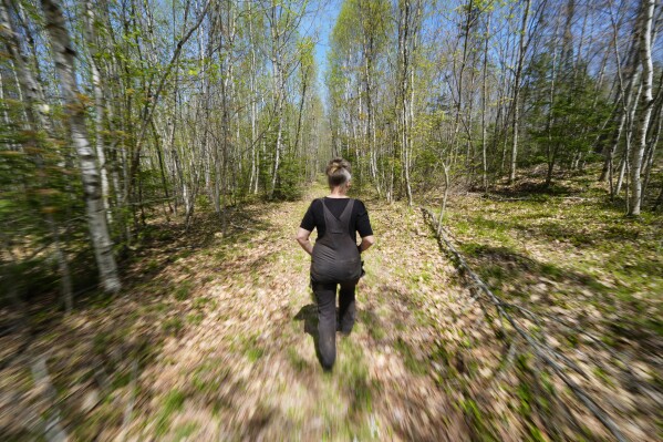 Heather Donahue walks on a rural road, Tuesday, May 13, 2025, in Freedom, Maine. (AP Photo/Robert F. Bukaty)