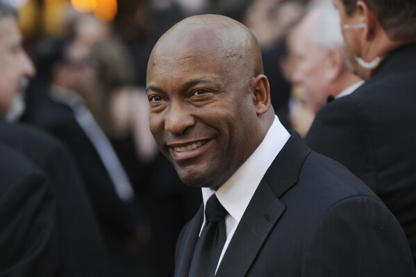 
              FILE - In this Feb. 24, 2008 file photo, director John Singleton arrives at the 80th Academy Awards in Los Angeles. Oscar-nominated filmmaker John Singleton has died at 51, according to statement from his family, Monday, April 29, 2019. He died Monday after suffering a stroke almost two weeks ago.  (AP Photo/Chris Pizzello, File)
            