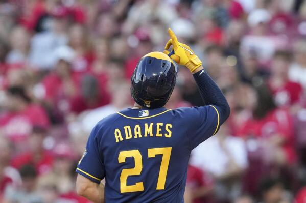 Milwaukee Brewers' Willy Adames (27) scores after hitting a solo home run during the fifth inning of the team's baseball game against the Cincinnati Reds, Friday, June 17, 2022, in Cincinnati. (AP Photo/Jeff Dean)