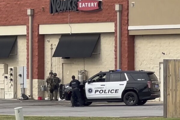 Police respond to an incident in the Lewis Crossing Shopping Center on Saturday, April 6, 2024 in Conway, Ark. Shots were fired, although it wasn’t immediately clear where the shots came from. Arkansas State Police were investigating the incident as an “officer-involved shooting,” KATV-TV reported. (KATV via AP)