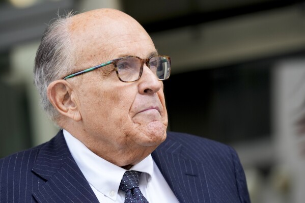 FILE - Rudy Giuliani speaks with reporters as he departs the federal courthouse, May 19, 2023, in Washington. Giuliani is not disputing that he publicly made statements about two Georgia election workers that were defamatory and false, but he contends they were constitutionally protected statements, according to a statement filed in court. (AP Photo/Patrick Semansky, File)