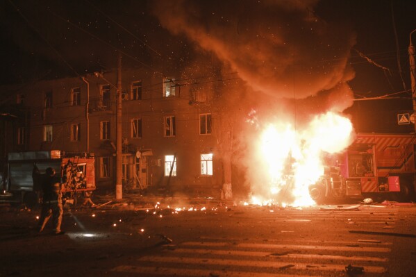 Firefighter's vehicle is seen on fire after Russian drone strikes on residential neighborhood in Kharkiv, Ukraine, on Thursday, April. 4, 2024. (AP Photo/George Ivanchenko)