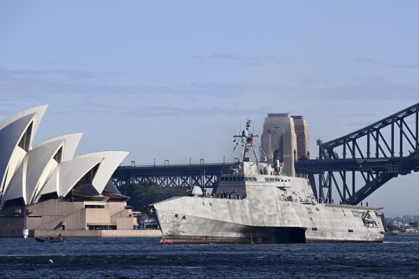 The USS Canberra (LCS-30) sails past the Sydney Opera House as it arrives at the Royal Australian Navy's Fleet Base East, in Sydney, Tuesday, July 18, 2023. The USS Canberra will be commissioned into service in Sydney on Saturday. (Dan Himbrechts/AAP Image via AP)