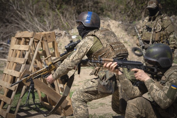 Members of the Siberian Battalion, which was formed mostly of volunteer Russian citizens, of the Ukrainian Armed Forces' International Legion, practice during military exercises, amid Russia's attack on Ukraine, at an undisclosed location in Kyiv region, Ukraine, Wednesday, Apr. 10, 2024. (AP Photo/Efrem Lukatsky)