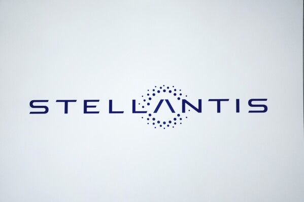 FILE - A Stellantis logo is shown at the North American International Auto Show in Detroit, Sept. 13, 2023. Automaker Stellantis said Tuesday, Oct. 31, that the autoworkers strike in North America is expected to cost the company around 750 million euros ($795 million) in profits, though less than its North American competitors. (AP Photo/Paul Sancya, File)