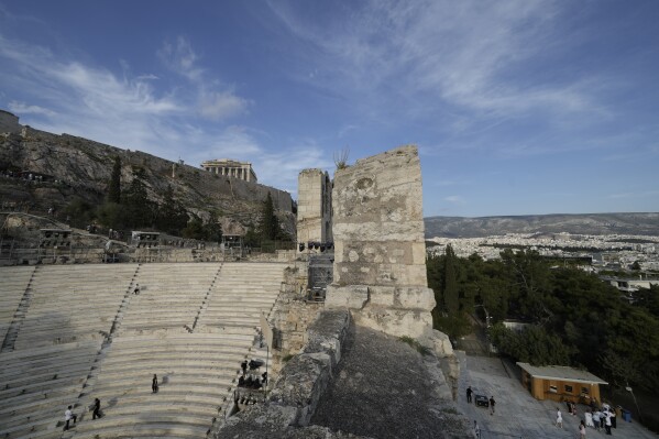 Ushers prepare the Odeon of Herodes Atticus ahead of the dress rehearsal of Giacomo Puccini's "Turandot" by the Greek National Opera under the ancient Acropolis hill during the 70th Athens Epidaurus Festival in Athens, Greece, Friday, May 30, 2025. (AP Photo/Thanassis Stavrakis)