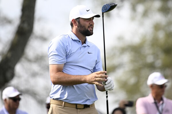 Scottie Scheffler watches his tee shot on the 11th hole during the second round of the Arnold Palmer Invitational golf tournament, Friday, March 8, 2024, in Orlando, Fla. (AP Photo/Phelan M. Ebenhack)