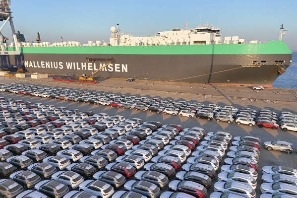 This aerial view shows new cars waiting to be exported at a dockyard in Yantai in eastern China's Shandong province Thursday, Nov. 2, 2023. China's imports rose in October while exports fell for a sixth straight month compared with a year earlier, partly due to lower export prices. (Chinatopix Via AP)