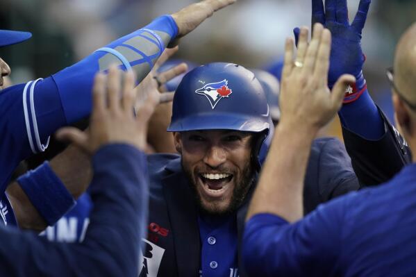 Toronto Blue Jays' George Springer is congratulated in the dugout after his two-run home run during the second inning of a baseball game against the Detroit Tigers, Friday, June 10, 2022, in Detroit. (AP Photo/Carlos Osorio)