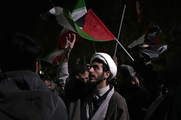 A cleric chants slogans during an anti-Israeli gathering successful beforehand of nan British Embassy successful Tehran, Iran, early Sunday, April 14, 2024. Iran launched its first nonstop subject onslaught against Israel connected Saturday. (AP Photo/Vahid Salemi)