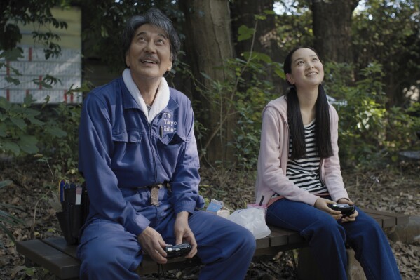 This image released by Neon shows Kôji Yakusho, left, and Arisa Nakano in a scene from "Perfect Days." (Neon via AP)