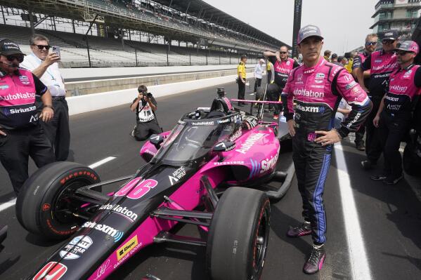Helio Castroneves, of Brazil, stands by his car during qualifications for the Indianapolis 500 auto race at Indianapolis Motor Speedway, Saturday, May 21, 2022, in Indianapolis. (AP Photo/Darron Cummings)