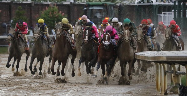 FILE - Luis Saez rides Maximum Security, second from right, to the finish line during the 145th running of the Kentucky Derby horse race at Churchill Downs, May 4, 2019, in Louisville, Ky. Country House was declared the winner after Maximum Security was disqualified following a review by race stewards. Which post position has produced the most Derby winners? (AP Photo/John Minchillo, File)